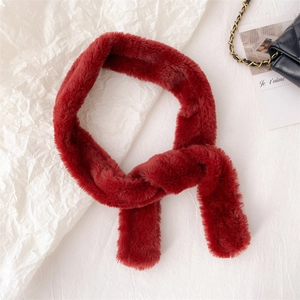 Detail of soft deep red faux fur texture on a warm winter scarf for cold weather