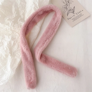 Close-up of soft pink faux fur scarf texture on a minimalist aesthetic background