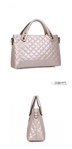 Detailed view of champagne gold quilted tote bag with metallic finish and gold hardware