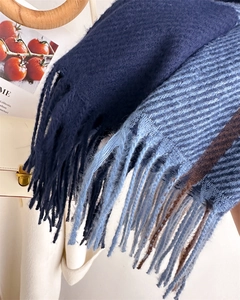 Detail of soft tassel fringe on dark blue and striped knit cashmere-feel scarves
