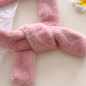 Close-up of soft pink faux cashmere scarf showing plush fluffy texture and knot detail