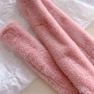 Close-up of soft pink faux cashmere scarf texture showing plush and smooth fur material