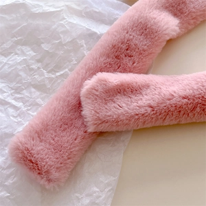 Close-up of soft pink faux cashmere texture with thick plush fibers for winter warmth