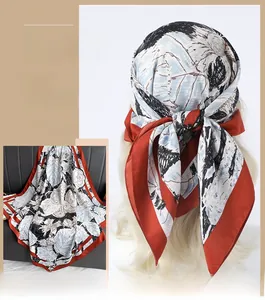 Détail d'un foulard en soie à croquis floral, drapé sur cheveux et posé sur cuir