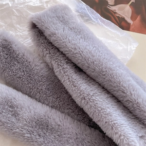 Detail of soft light gray faux fur scarf texture with dense and fluffy fibers