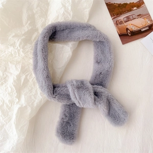 Detail of grey faux fur scarf with soft texture and criss-cross knot design for winter