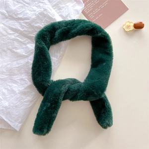 Detailed texture of thick dark green faux fur scarf with cross-insert design