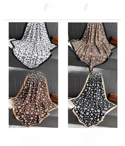 Four color options of floral silk scarves shown on a luxury leather background