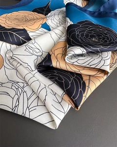 Detailed view of large camellia print on twill silk scarf with elegant drape texture