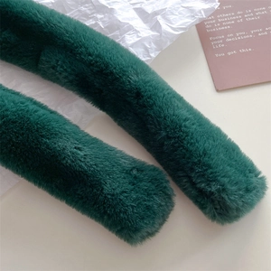 Detailed macro view of plush emerald green faux fur scarf with soft dense fiber texture