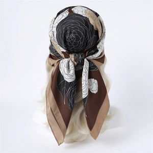 Detail of 90cm floral silk scarf worn as a retro headwrap featuring camellia prints