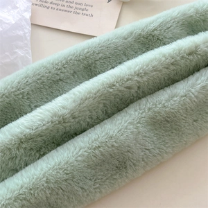 Close-up detail of soft mint green faux fur scarf showing dense and plush texture