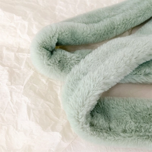 Close-up of soft mint green faux fur scarf showing dense texture and plush material