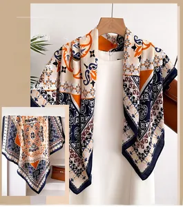 Detailed view of paisley silk-feel large scarf draped on a hanger over a white shirt