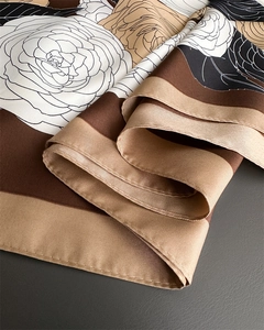 Macro detail of twill silk scarf showing classic large camellia floral print and edge stitching