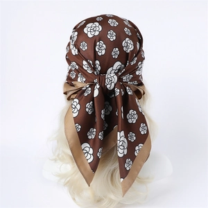 Detail of silk-like brown headscarf with white camellia print on model head