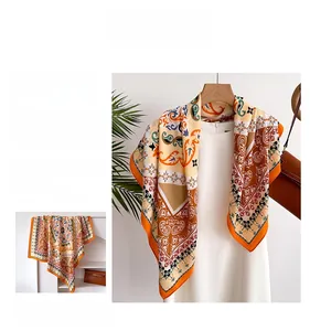 Detail of silk scarf with geometric floral pattern paired with a white dress and brown bag