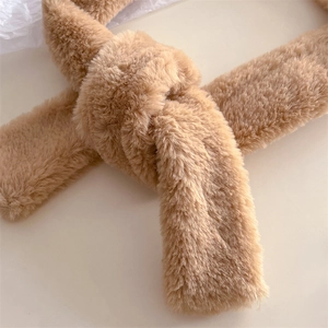 Close-up of soft khaki faux fur scarf featuring a decorative twisted knot detail