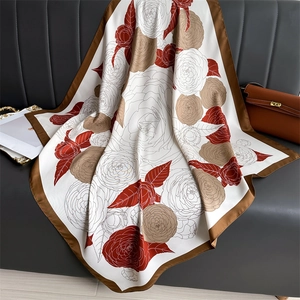 90cm silk-like square scarf with floral print and contrast border on leather sofa