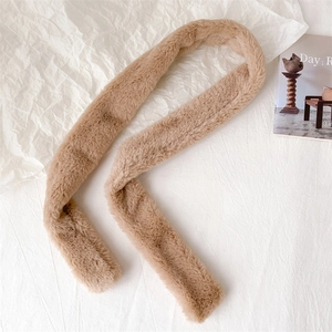 Detailed view of light camel faux cashmere scarf featuring soft plush texture on white paper