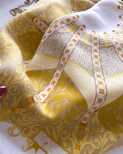 Detailansicht eines gelben Seidenschals mit eleganten Barock- und Reitermustern