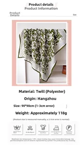 Close-up of green camellia flower print silk scarf with polka dot patterns and edges