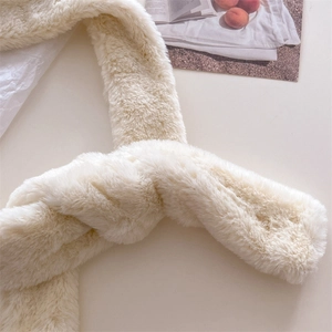 Close-up of fluffy off-white faux fur scarf with soft texture and warm winter design
