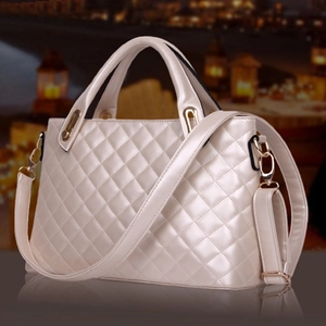 Elegant pearlescent white quilted handbag with golden hardware and round top handles