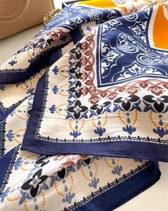 Detailed view of paisley silk scarf with vintage floral patterns and geometric borders
