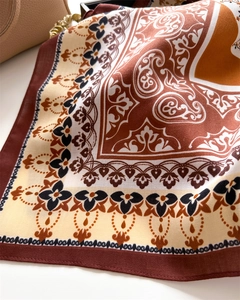 Detail of silk scarf showing vintage paisley patterns and refined twill texture