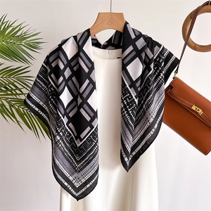 Close-up of geometric pattern and houndstooth texture on silk-like scarf drape
