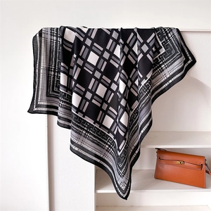 Detail of a 90cm checkered silk scarf featuring houndstooth edges and a soft drape texture