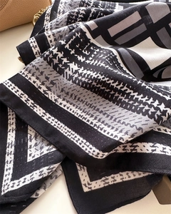 Detailed view of 90cm square scarf featuring houndstooth and geometric grid patterns