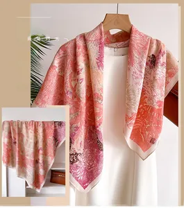 Detail of silk-like scarf with tropical floral print and elegant herringbone weave texture
