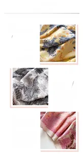 Detailed macro view of herringbone silk scarf edges with intricate floral patterns