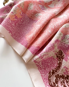 Detail of premium silk-like scarf with vintage floral and snake print patterns