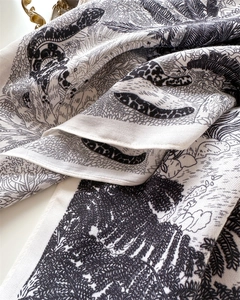 Detail of vintage silk scarf featuring tropical leopard and palm tree print patterns