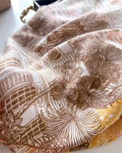 Detailed shot of tropical palm and architecture prints on twill silk scarf fabric