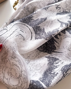 Macro detail of retro plant and floral print on soft silk-feel square scarf fabric