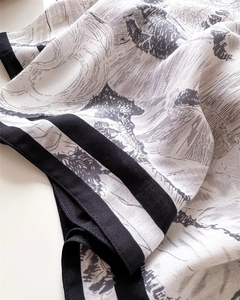 Close-up of squirrel print silk scarf showing soft texture and elegant black border