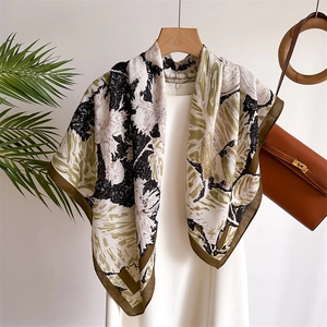 Silk feel shawl with squirrel and plant print, styled with a dress and leather bag