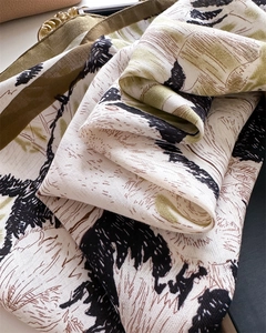 Macro view of abstract olive green and grey ink pattern on thick silk texture scarf