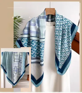 Close-up of elegant silk-like square scarf featuring geometric prints and chain patterns