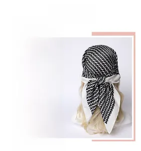 Detail of silk-like satin headscarf featuring geometric patterns and elegant draping