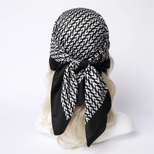 Detail of silk-like scarf with black and white V-pattern tied on back of head