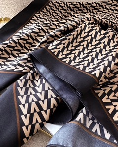 Close-up of silk scarf with vintage V-pattern and elegant satin texture in tri-color