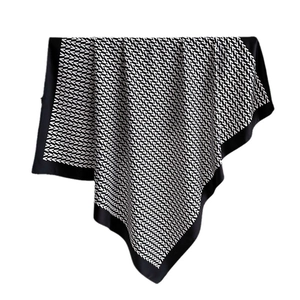 Elegant black and white V-pattern silk scarf featuring a premium satin finish texture