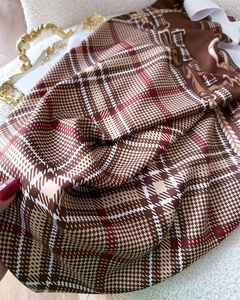 Close-up of vintage check pattern silk scarf with horse harness and chain print details