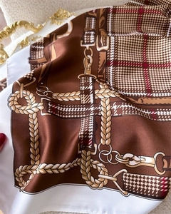 Close-up of vintage plaid silk scarf with horsebit patterns and rope textures