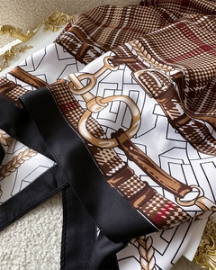Close-up of silk scarf showing vintage plaid patterns, gold chains and leather belt details